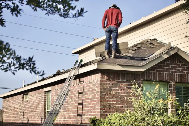 Professional roofer working on a residential roof in Seven Oaks